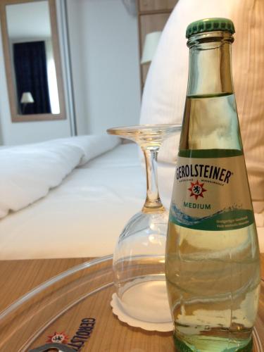 a bottle of beer sitting on a glass table at Sapia Hotel Rheinsberg in Bad Säckingen