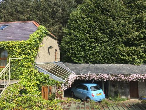 a blue car parked in front of a house at Crotlieve Barn in Rostrevor