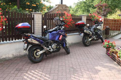 two motorcycles are parked next to a fence at Penzion U Králíků in Kurdějov