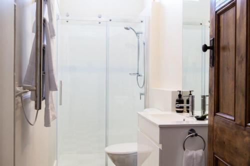 uma casa de banho com um chuveiro, um WC e um lavatório. em Highbury Apartments em Launceston
