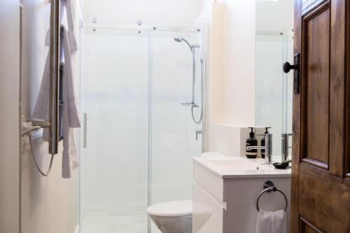 a bathroom with a shower and a toilet and a sink at Highbury Apartments in Launceston