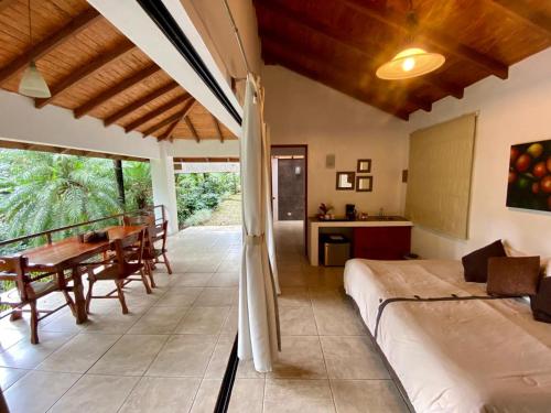 a bedroom with a bed and a table and chairs at Argovia Ecolodge in Tapachula