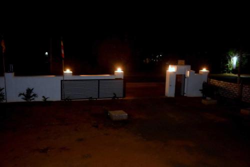 two lit candles on top of a building at night at Wingate Hotel Wilgamuwa in Wasgamuwa