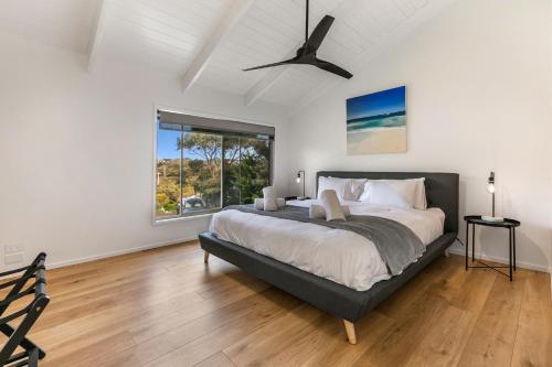 a bedroom with a large bed and a window at 1 Oak - Rye Back Beach Accommodation in Saint Andrews Beach