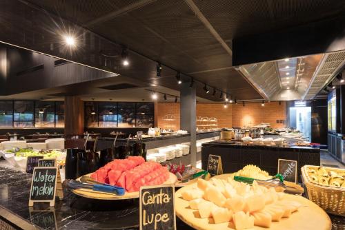 a restaurant with a buffet of food on display at La Vela Khao Lak - SHA Extra Plus in Khao Lak