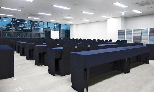 a conference room with black tables and chairs at Airsky Hotel Incheon in Incheon