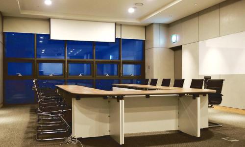 a conference room with a large table and chairs at Airsky Hotel Incheon in Incheon