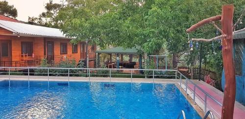 a large blue swimming pool next to a house at yenivadi in Antalya