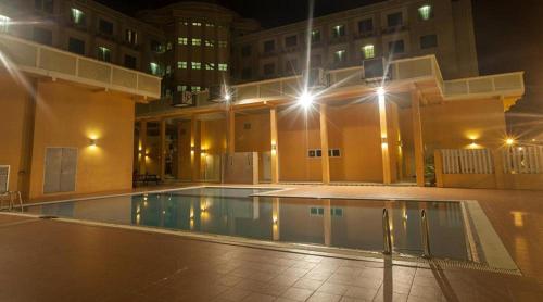 an empty swimming pool in a building at night at Hotel Seri Malaysia Lawas in Lawas