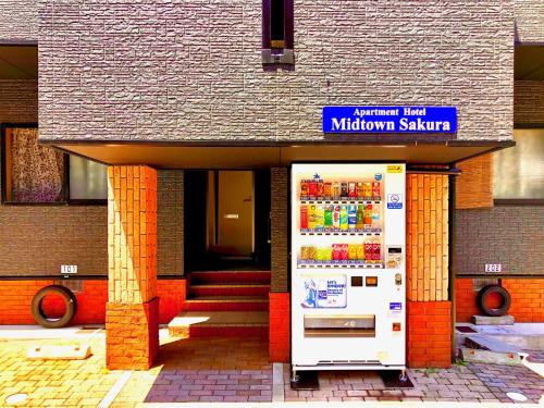 a vending machine in front of a building at Midtown Sakura Apartment House 102 予約者だけの空間 A space just for you in Katsuura