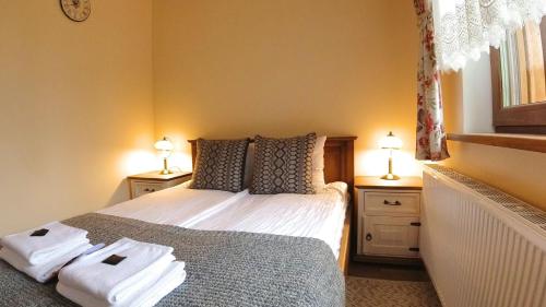 a bedroom with a bed with towels on it at Uroczysko starych sztolni in Szklarska Poręba