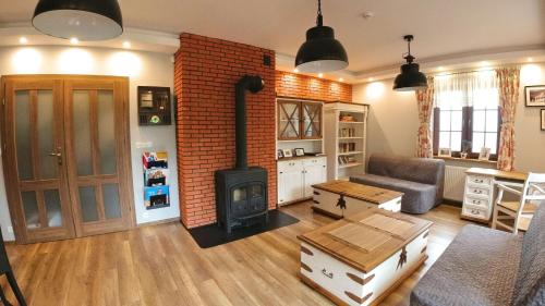 a living room with a fireplace and a stove at Uroczysko starych sztolni in Szklarska Poręba