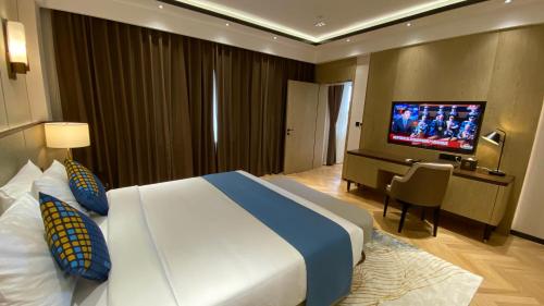 a hotel room with a large bed and a flat screen tv at Ocean Delight Boutique Hotel 海悦精品酒店 in Sihanoukville