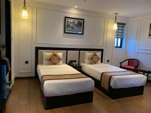 a hotel room with two beds in a room at Khanh Linh Hotel in Da Nang