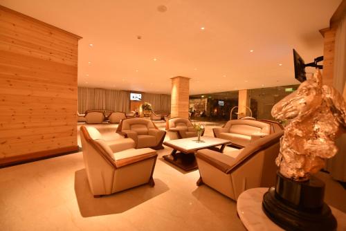 a lobby with a lot of chairs and a table at Araliya Red - Budget friendly Hotel- Where you find stunning 360 panoramic view of Nuwara Eliya in Nuwara Eliya