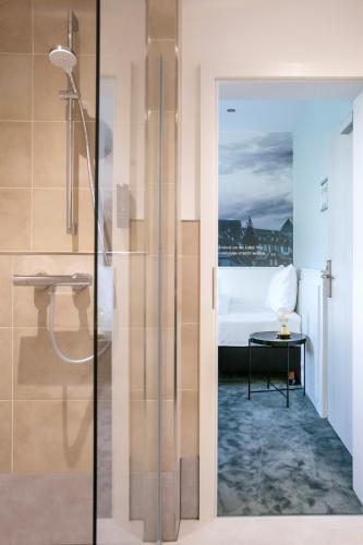 a bathroom with a shower and a bed at Hotel Huss Limburg in Limburg an der Lahn