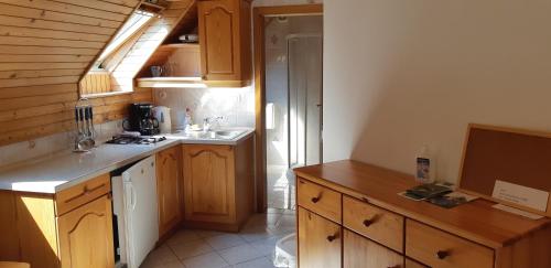 a kitchen with wooden cabinets and a sink and a counter at Apartment Zorc in Trenta