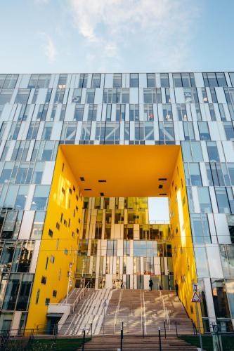 a large yellow building with a staircase in front at ibis budget Saint-Étienne Centre Gare Châteaucreux in Saint-Étienne