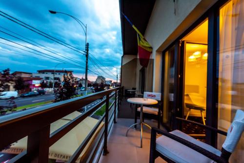 a balcony with a table and a view of a street at Casa Budulan in Drobeta-Turnu Severin