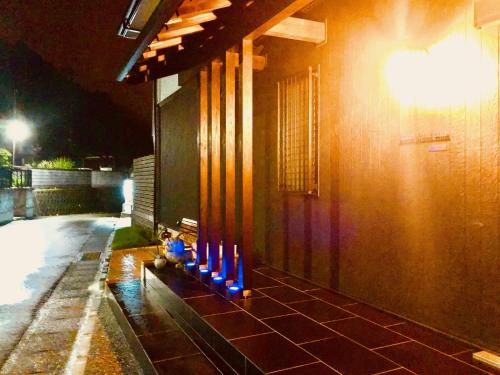 a row of blue lights on the side of a building at Ricco Mond Hills Apartment Houseアパートタイプの宿は宿泊者と接しない 安全な宿 in Nachikatsuura