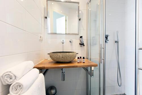 a bathroom with a sink and a bath tub at Quentin Golden Bear Hotel in Amsterdam