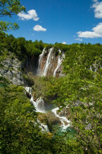 a waterfall in the middle of a forest at 10 minutes walk to the lakes in Plitvička Jezera