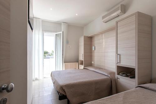 Postel nebo postele na pokoji v ubytování Hotel Primiana