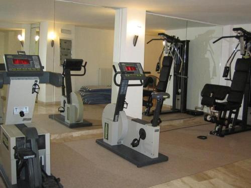 a gym with several exercise bikes and a mirror at Hotel Excelsior Bay in Malcesine