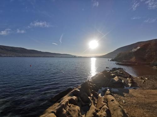 a view of a body of water with the sun in the sky at Laura's dream Appartments in Pag
