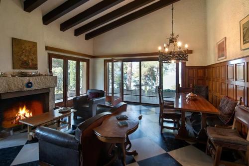 a living room with a fireplace and a table and chairs at Villa Moskoff Amina in Platamonas