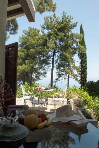a table with fruit on it with trees in the background at Villa Moskoff Amina in Platamonas