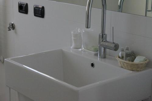 a white sink with a faucet in a bathroom at FairView in Bardolino