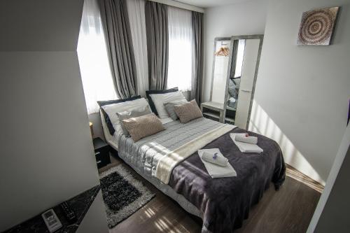 a bedroom with a bed with two towels on it at Vila Lemic Postojna in Postojna