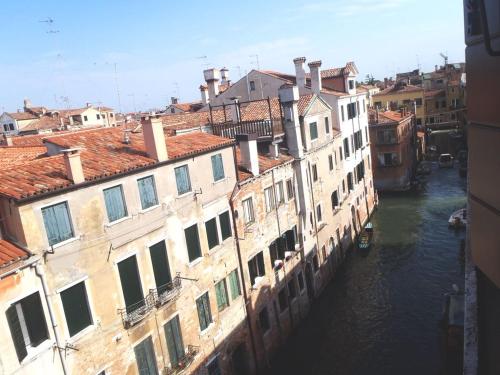 a group of buildings next to a canal with water at Cà Dolce Attico in Venice