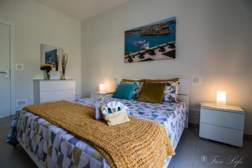a bedroom with a bed and two night stands at Mgarr Waterfront Cosy Apartment 3 by Ghajnsielem Gozo in Mġarr