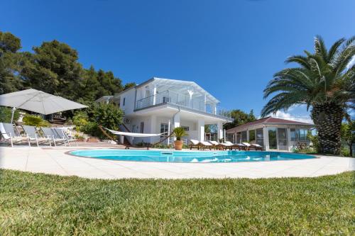 a house with a swimming pool in front of a house at B&B White House in Peschici