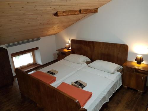 a bedroom with a large bed with two chairs at Farmhouse Cvetje in Tolmin