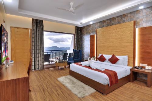 a hotel room with a bed and a balcony at Ekant Retreat Resort in Chail