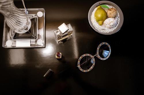 a table with a necklace and a ring and a bowl of pearls at Donna Carolina Luxury rooms in Cefalù