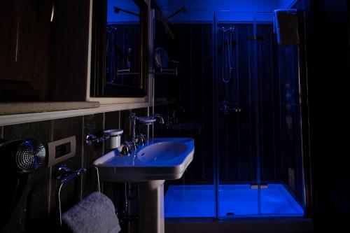 a bathroom with a sink and a shower at Donna Carolina Luxury rooms in Cefalù