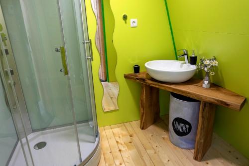 a bathroom with a sink and a shower at Glamping Health Resort in Kamnik