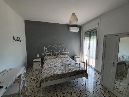 a bedroom with a bed with a gray wall at Il Tamburino Lucio in San Gemini