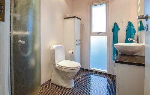 a bathroom with a toilet and a sink at Awesome Home In Sunds With House Sea View in Sunds