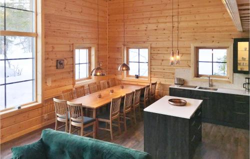 a dining room with a large wooden table and chairs at Amazing Home In Vemdalen With Wifi in Vemdalen