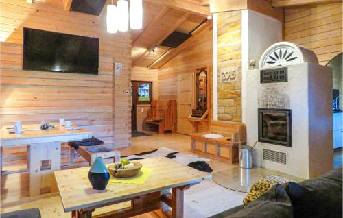 a living room with a wooden wall with a fireplace at Gorgeous Home In Merzalben With Wifi in Merzalben