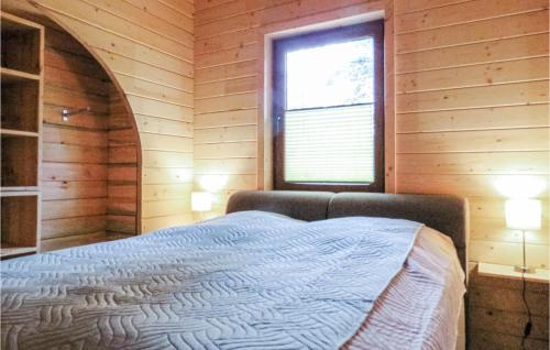 a bedroom with a bed in a wooden room at Nice Home In Merzalben With 2 Bedrooms And Wifi in Merzalben