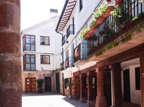 an alley in an old town with buildings at Apartamentos Rurales Altuzarra in Ezcaray