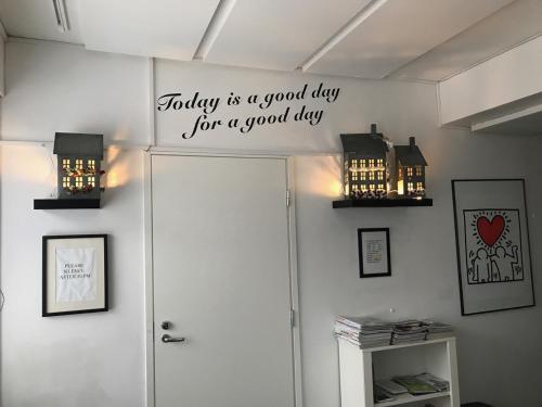 a sign above a door with a good day for a good day at Tapulitalo Guesthouse in Turku