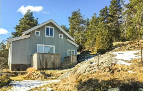 a house on top of a hill with trees at 3 Bedroom Lovely Home In Strömstad in Krokens Gård