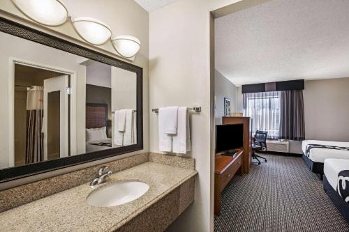 a hotel room with a sink and a mirror at La Quinta by Wyndham N Little Rock - McCain Mall in Little Rock